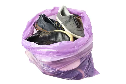 Old shoes in trash bag