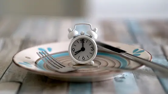 Alarm clock on a plate sitting on a table