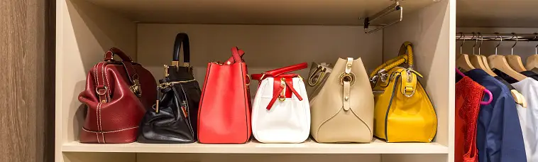 Purse collection organized on a closet shelf