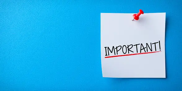 'Important' written on a white sticky note with a red pin and blue background