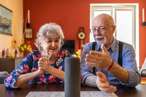 Senior couple excited about using tool such as Alexa