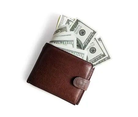 Brown wallet with dollar bills sticking out