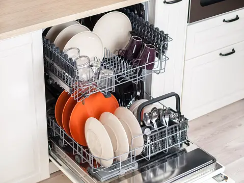 Open dishwasher stacked neatly with dishes