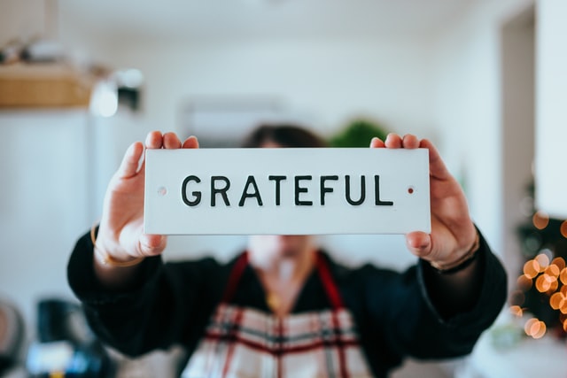 man holding grateful sign